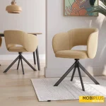 Sillas de comedor giratorias Cork tapizadas en tela mostaza con patas metálicas negras tipo araña.