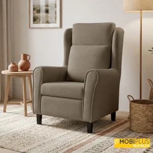 Sillón relax orejero Harmony en tela color taupe en rincón de lectura decorado, de MobiPlus Muebles.